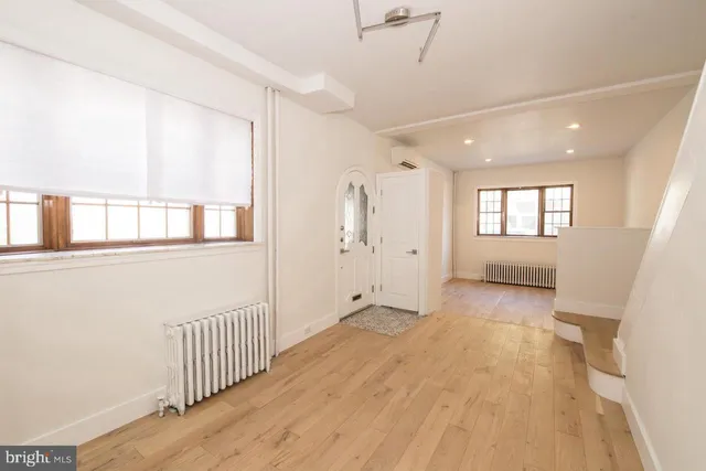 wooden floor in an empty room with a window and wooden floor