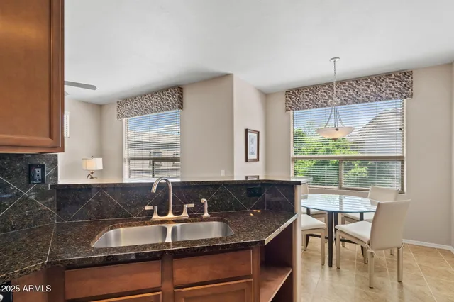 a kitchen with a sink and wooden cabinets