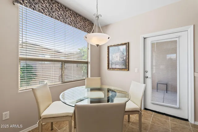 a dining room with furniture and window