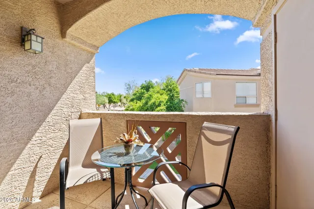 a view of a balcony dining table and chairs