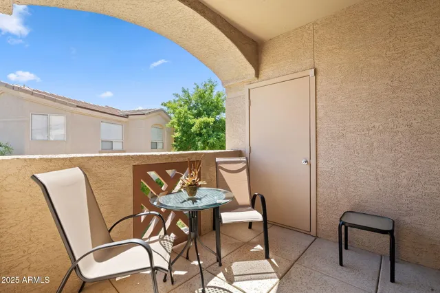 a view of a patio with table and chairs and potted plants