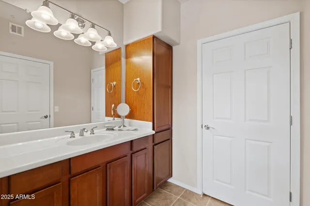 a bathroom with a sink vanity and a mirror