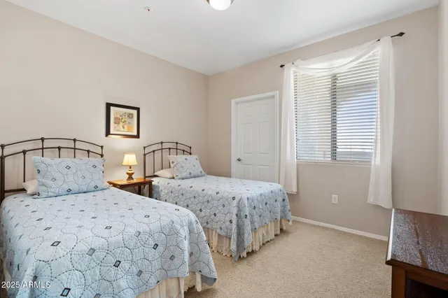 a bedroom with two beds and a window