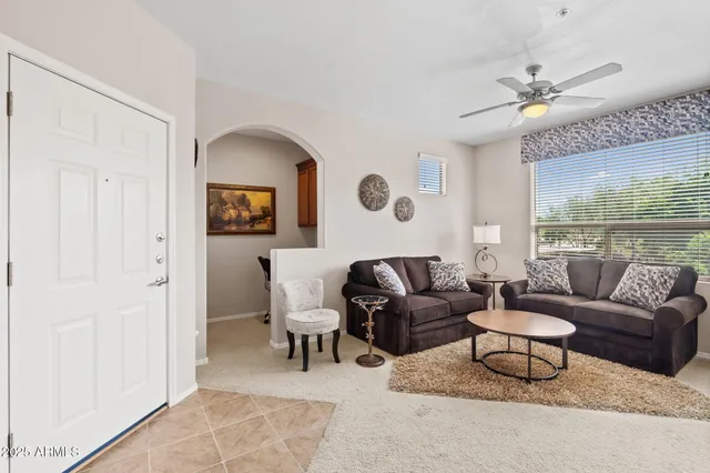 a living room with furniture and a large window