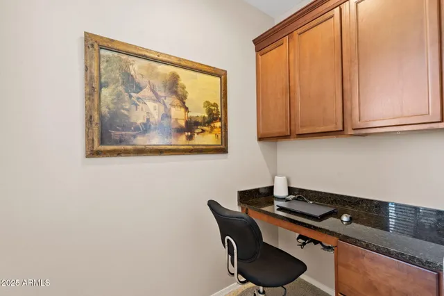 a room with a table and a painting on the wall