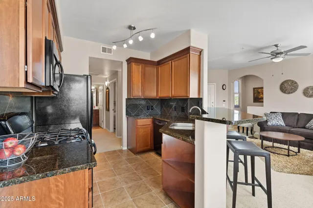 a kitchen with a refrigerator and a stove top oven