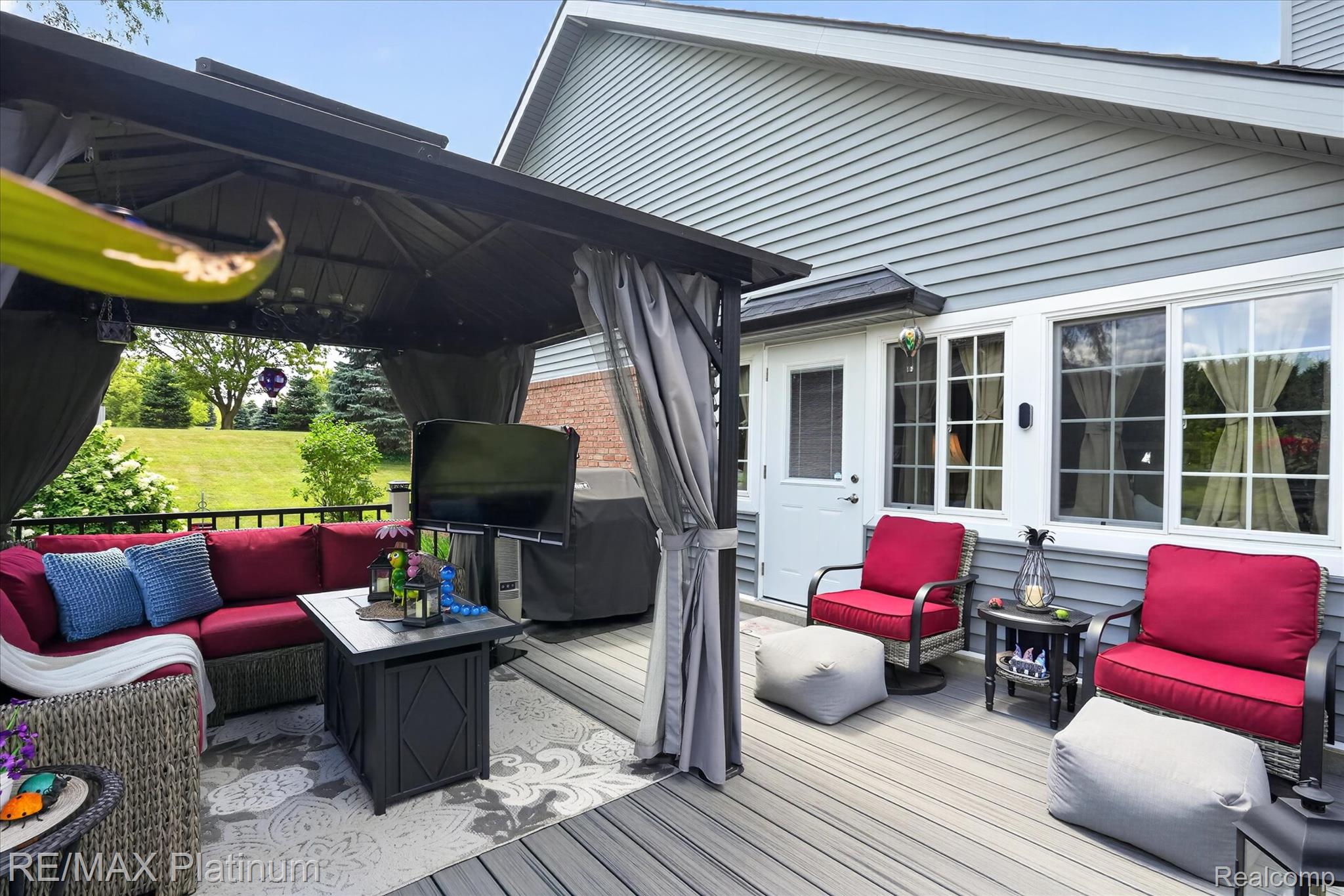 4457 Bradley Road Gregory, MI 48137 - Photo 37 of 79 Expansive composite deck featuring a dedicated covered seating area with privacy curtains