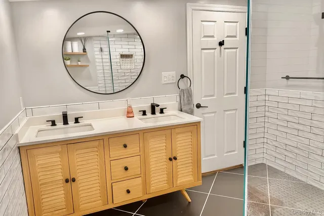 a bathroom with a sink a vanity and a mirror