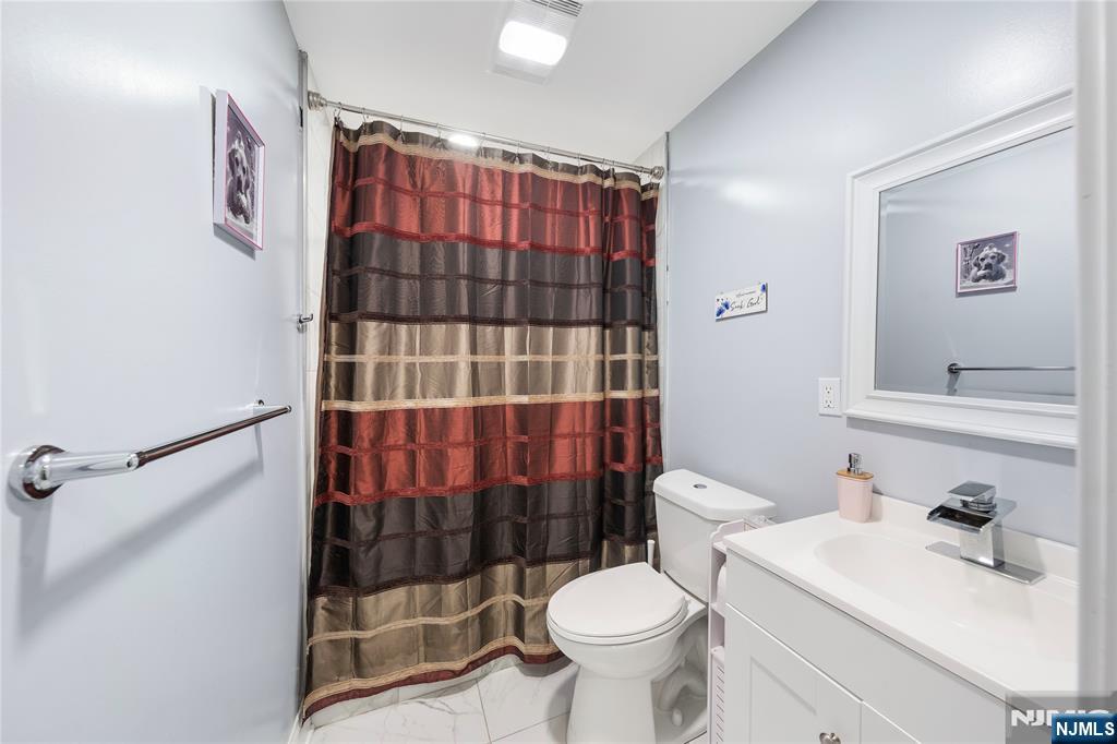 61-63 Keer Avenue Newark, NJ 07112 - Photo 13 of 33 a bathroom with a sink toilet and shower