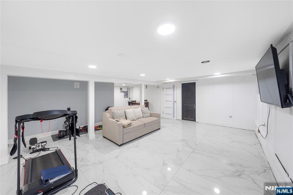 61-63 Keer Avenue Newark, NJ 07112 - Photo 20 of 33 a living room with furniture and a flat screen tv