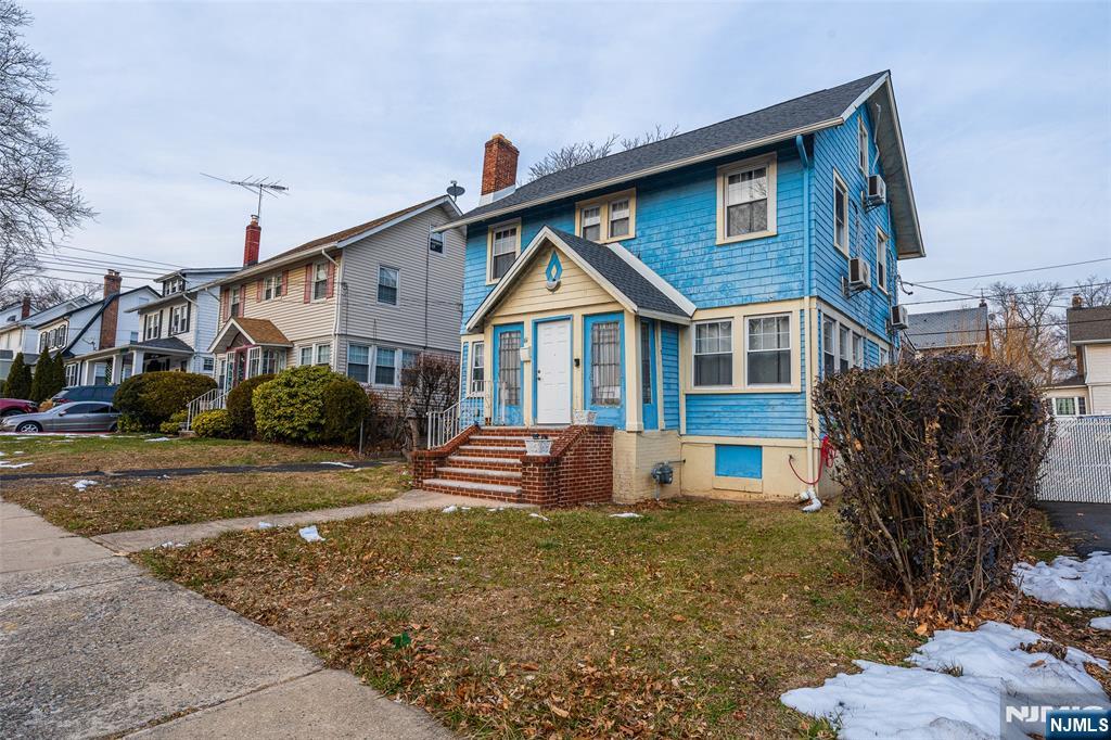 61-63 Keer Avenue Newark, NJ 07112 - Photo 25 of 33 a front view of a house with garden