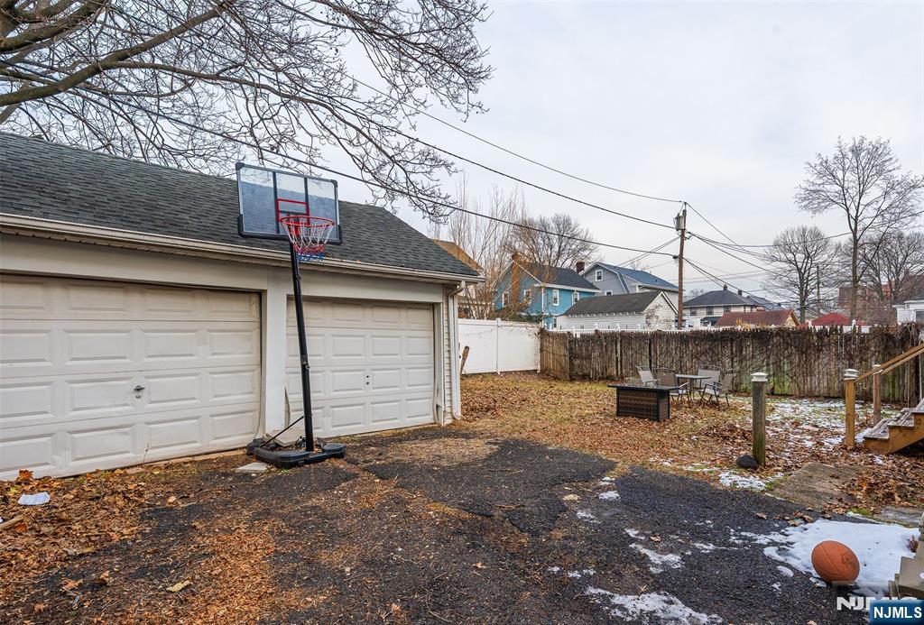 61-63 Keer Avenue Newark, NJ 07112 - Photo 26 of 33 a view of a house with a snow in the yard