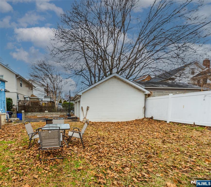 61-63 Keer Avenue Newark, NJ 07112 - Photo 27 of 33 a backyard of a house with yard and outdoor seating