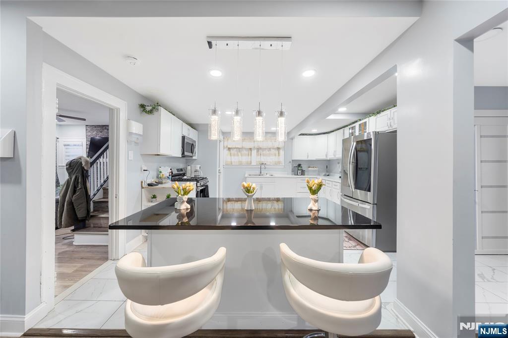 61-63 Keer Avenue Newark, NJ 07112 - Photo 5 of 33 a kitchen with a white table and chairs