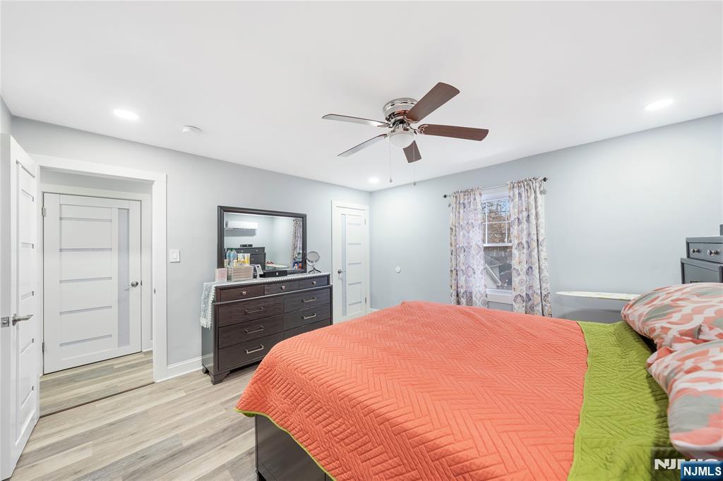 61-63 Keer Avenue Newark, NJ 07112 - Photo 9 of 33 a spacious bedroom with a bed and a dresser in it
