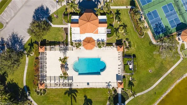 an aerial view of residential houses with outdoor space and swimming pool