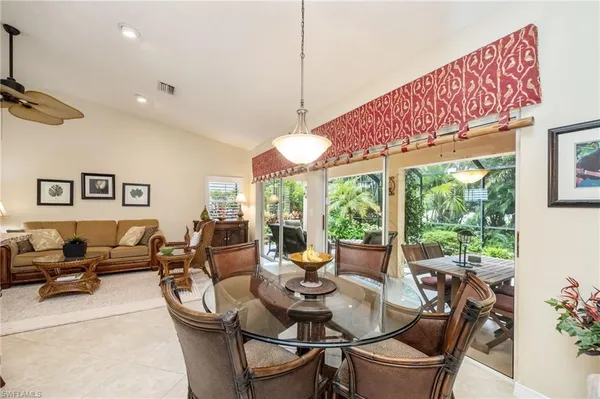 a view of a dining room with furniture large windows and wooden floor