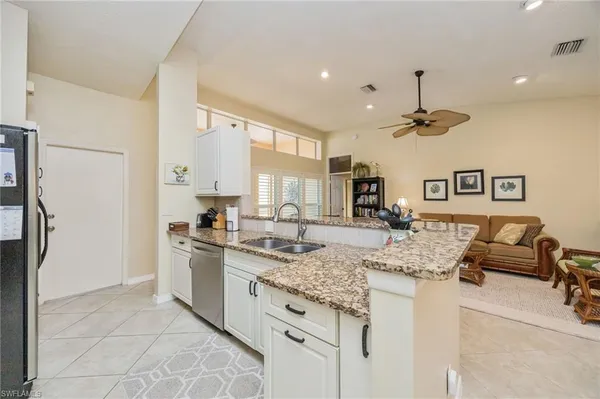 a kitchen with stainless steel appliances granite countertop a sink and cabinets