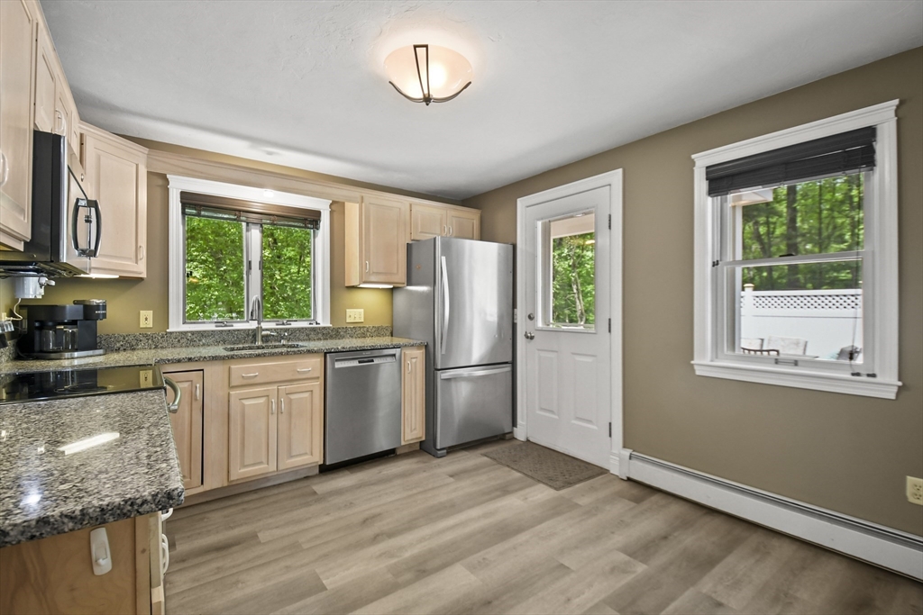 23 Cove Road Lunenburg, MA 01462 - Photo 17 of 42 a kitchen with a window a sink and a refrigerator
