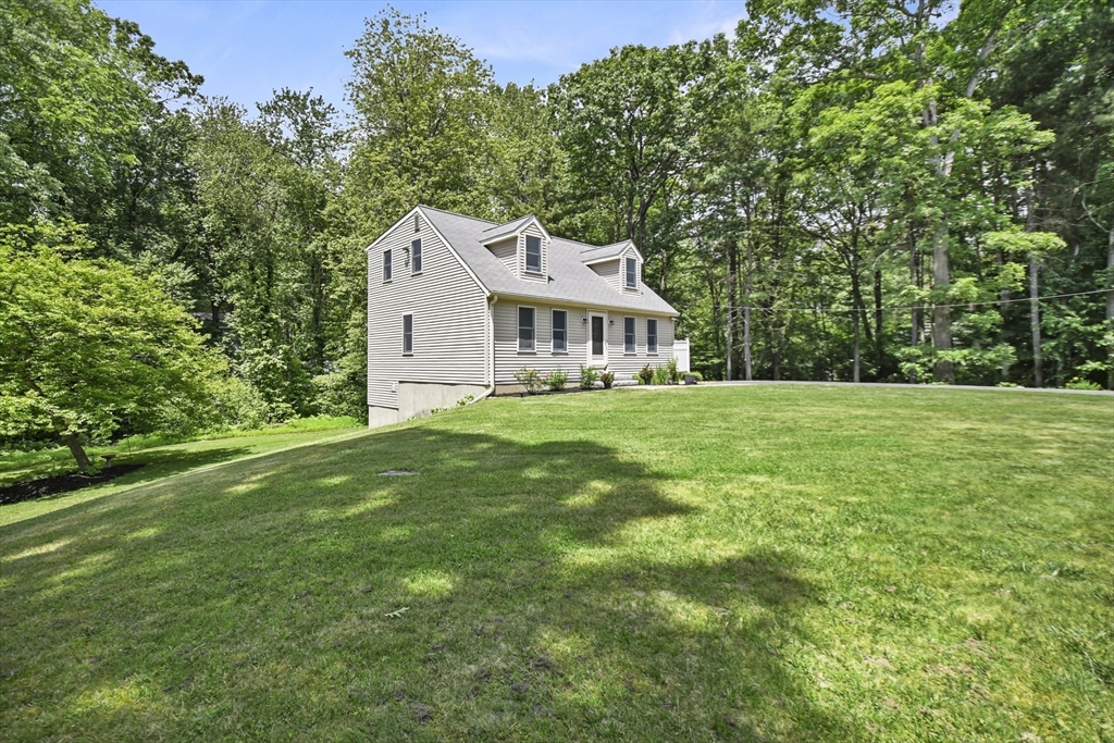 23 Cove Road Lunenburg, MA 01462 - Photo 3 of 42 a front view of a house with a garden