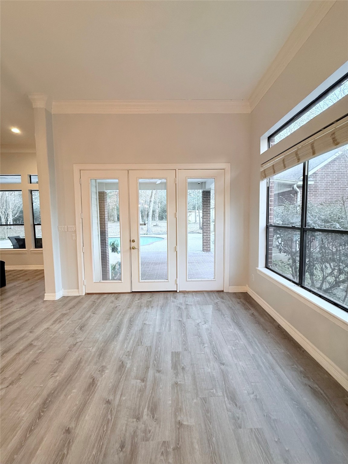 15567 Old Conroe Road Conroe, TX 77384 - Photo 18 of 31 a view of an empty room with a window and wooden floor