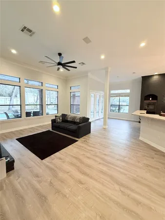 a kitchen with stainless steel appliances granite countertop a sink a stove and a wooden floors