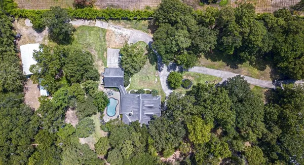 an aerial view of a house with a yard and lake view