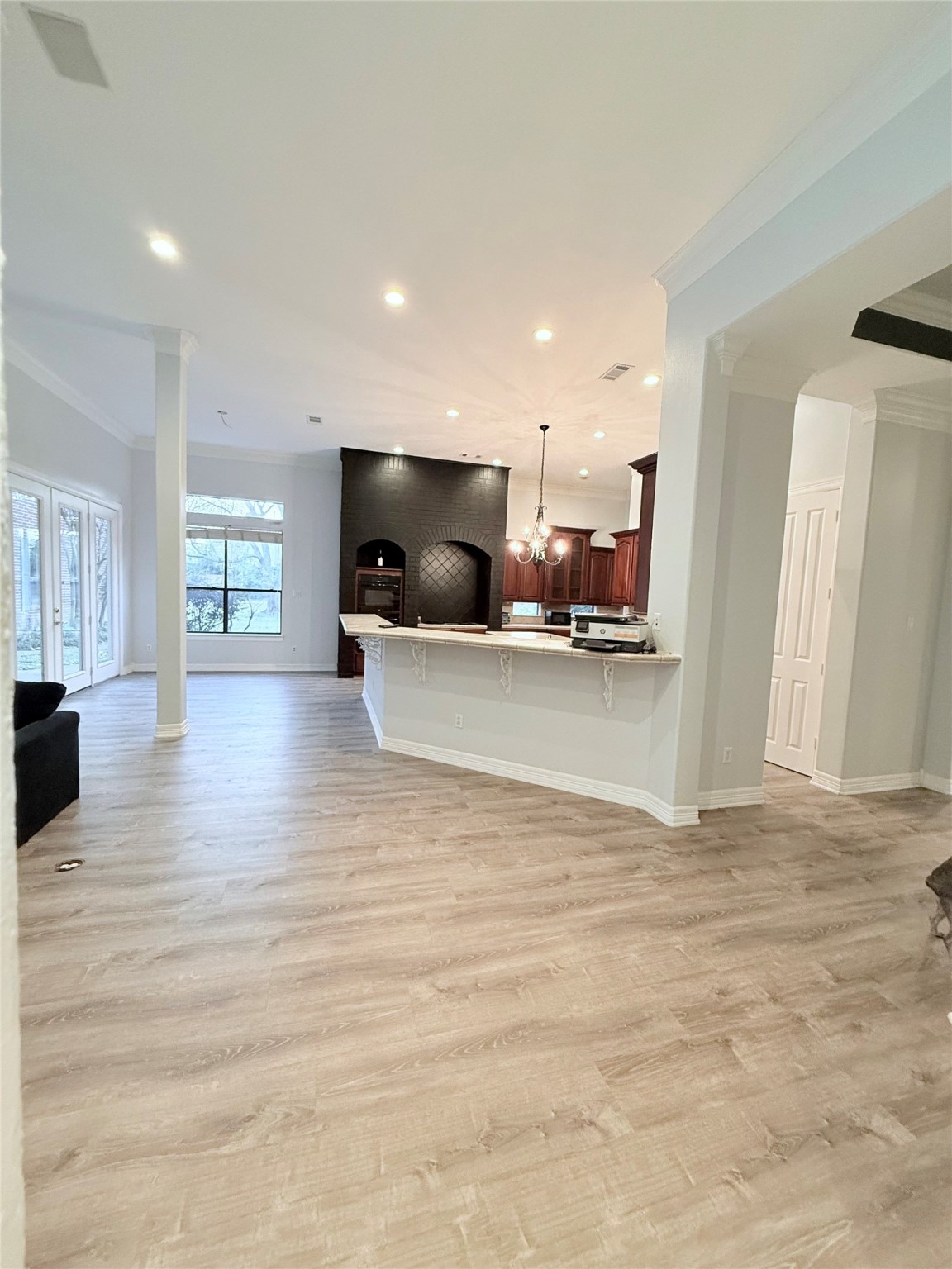 15567 Old Conroe Road Conroe, TX 77384 - Photo 21 of 31 a view of a living room a kitchen and a flat screen tv