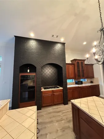 a kitchen with stainless steel appliances kitchen island granite countertop a stove and a sink
