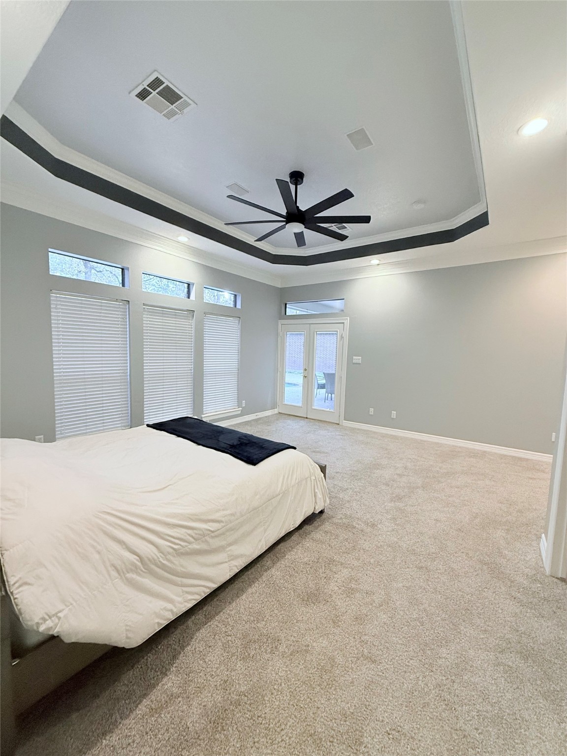 15567 Old Conroe Road Conroe, TX 77384 - Photo 28 of 31 a bedroom with a large bed window and a ceiling fan