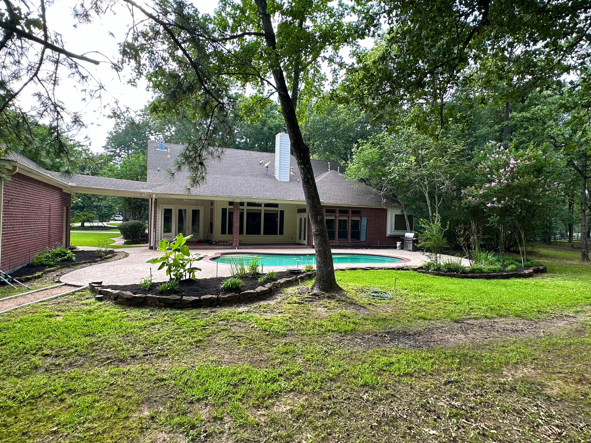 15567 Old Conroe Road Conroe, TX 77384 - Photo 7 of 31 a front view of house with a garden and trees