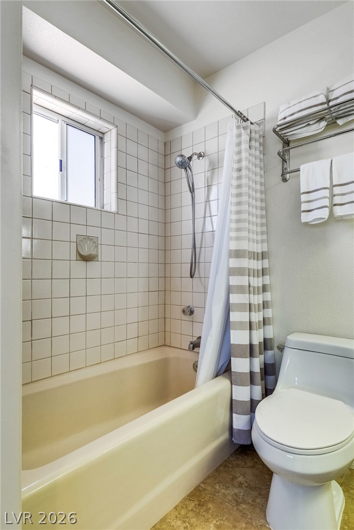 524 Swallow Cove Boulder City, NV 89005 - Photo 33 of 58 A well-appointed bath features a tiled shower/tub combo and ample towel storage.