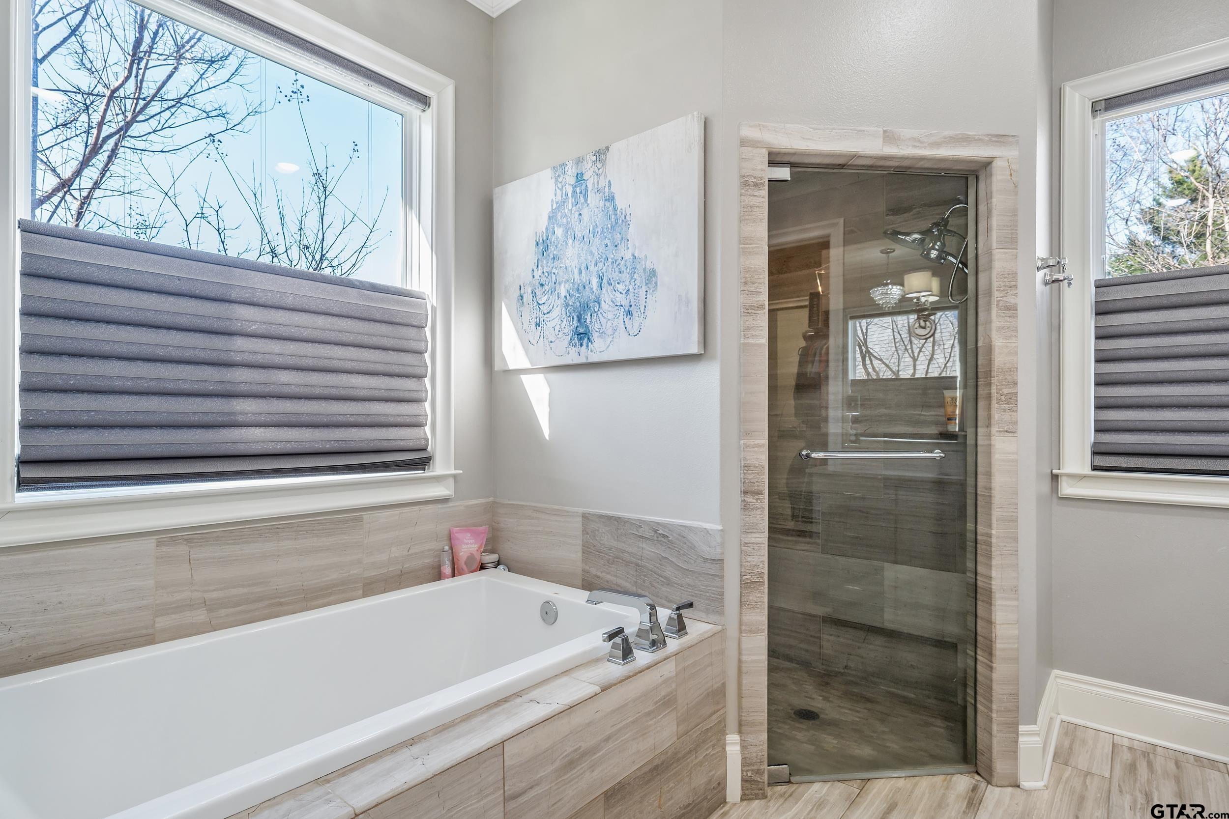 4535 Triggs Trace Tyler, TX 75709 - Photo 19 of 46 a bathroom with a tub and shower