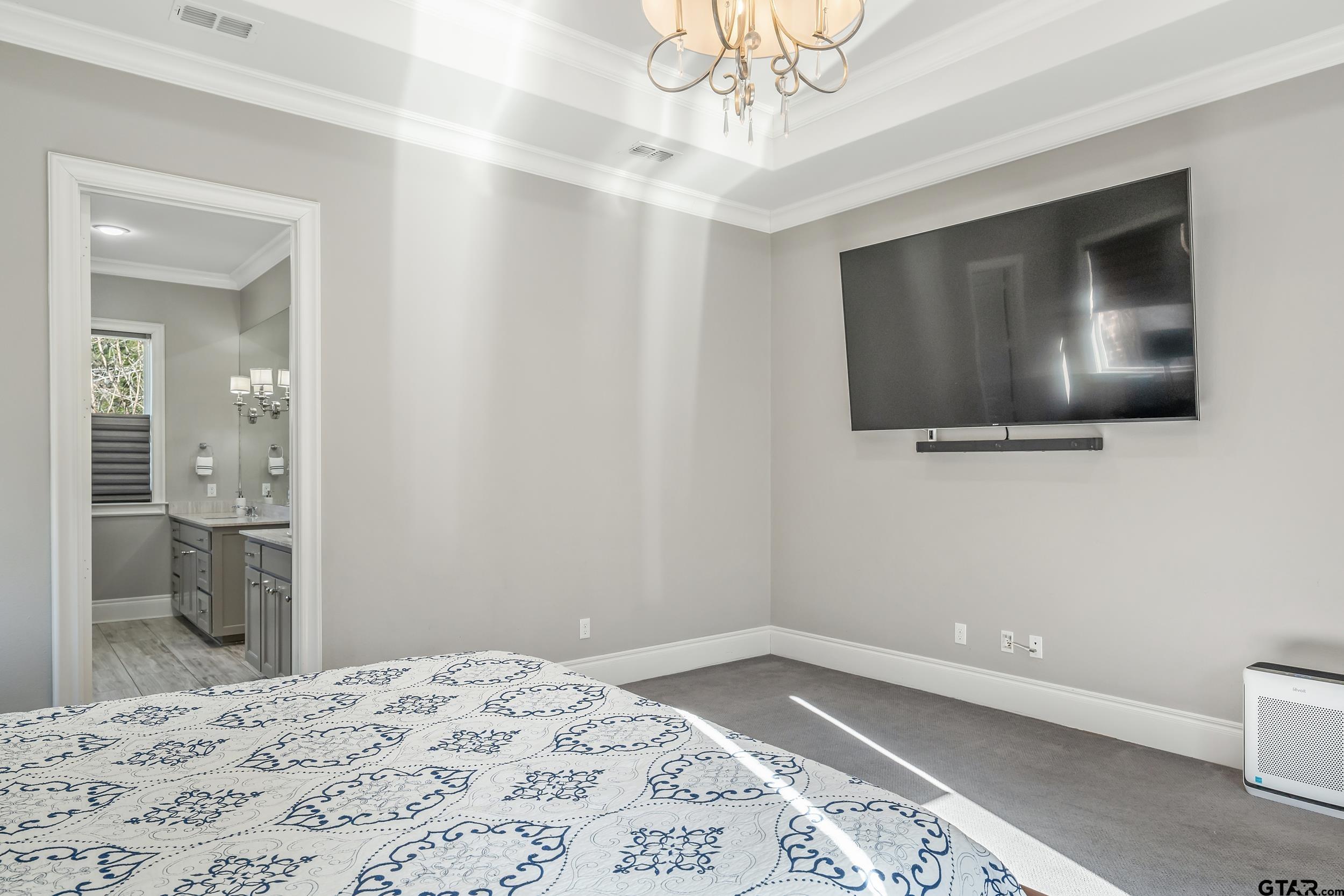 4535 Triggs Trace Tyler, TX 75709 - Photo 24 of 46 a bedroom with a bed and a flat screen tv