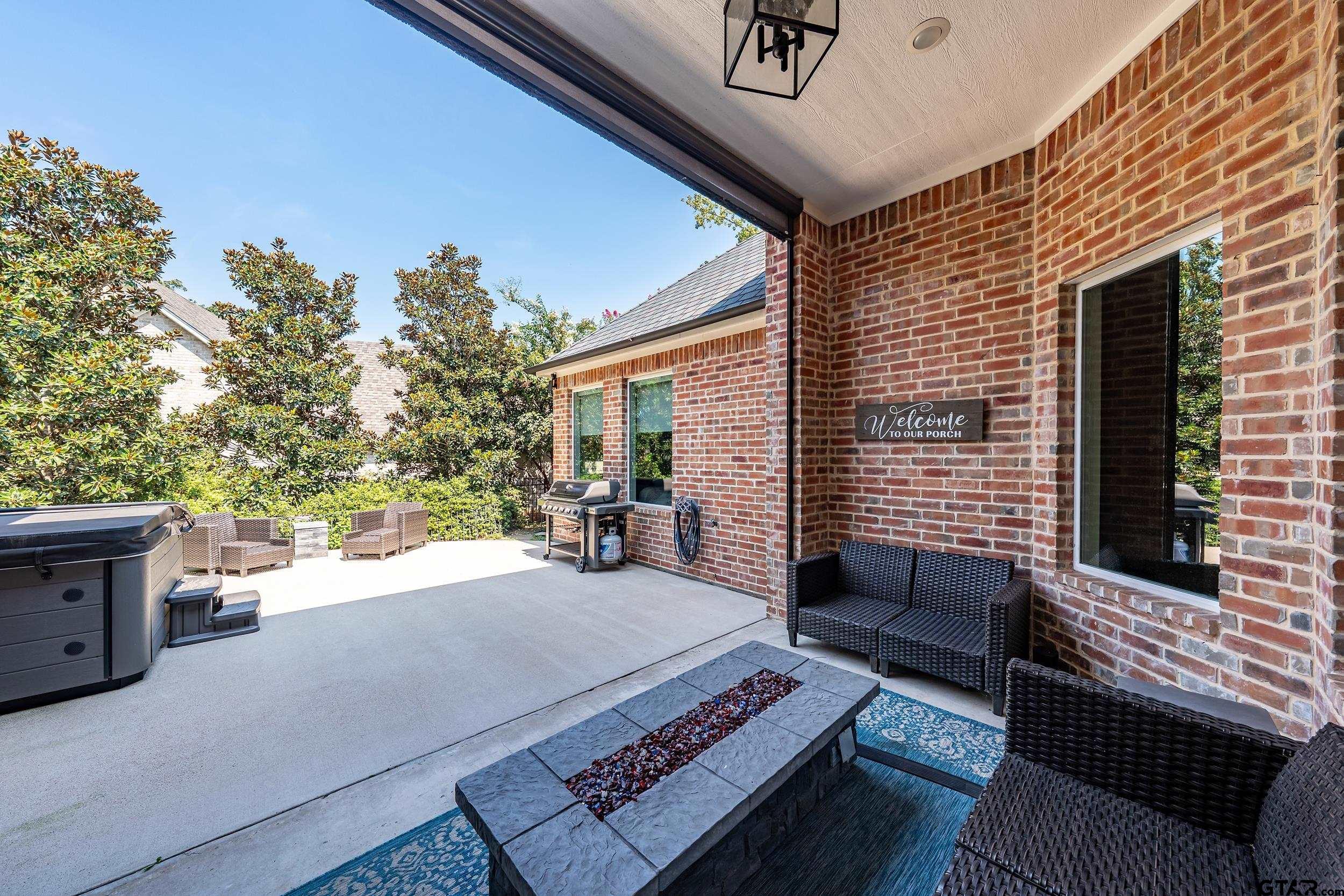 4535 Triggs Trace Tyler, TX 75709 - Photo 32 of 46 a view of a patio with couches and table and chairs with wooden floor and fence
