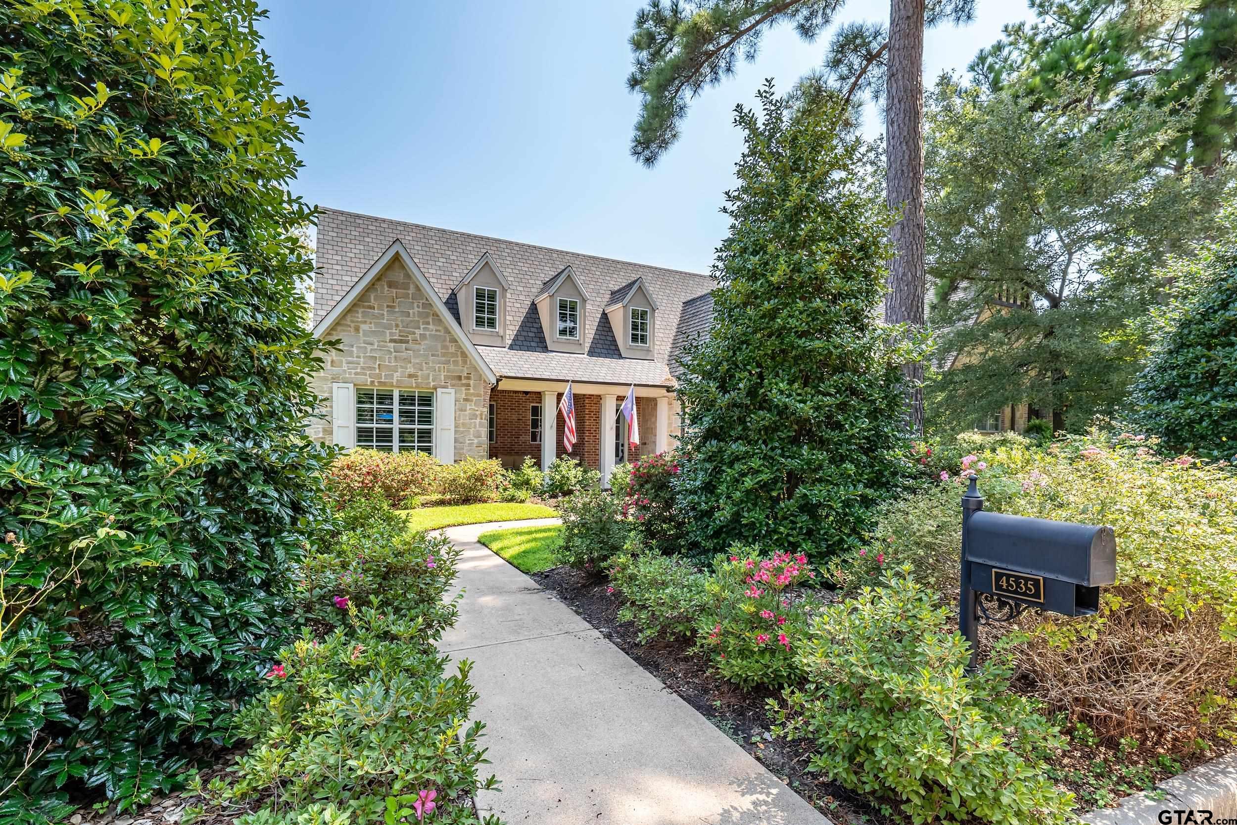 4535 Triggs Trace Tyler, TX 75709 - Photo 4 of 46 a front view of a house with a yard and fountain