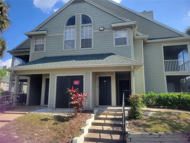 a front view of a house with yard and seating space