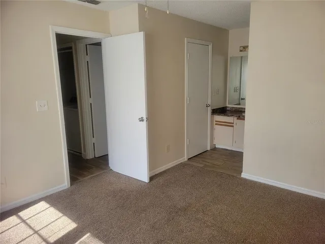 an empty room with windows and closet