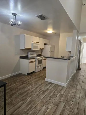 a kitchen with granite countertop a sink and steel appliances