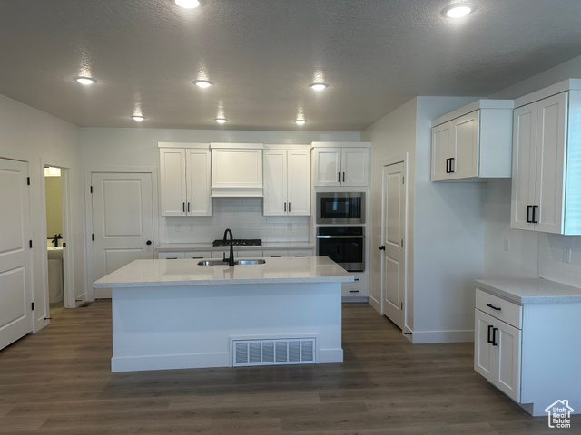 22 South Starlight Lane Mapleton, UT 84664 - Photo 4 of 17 Kitchen with appliances with stainless steel finishes, white cabinetry, decorative backsplash, recessed lighting, and a textured ceiling