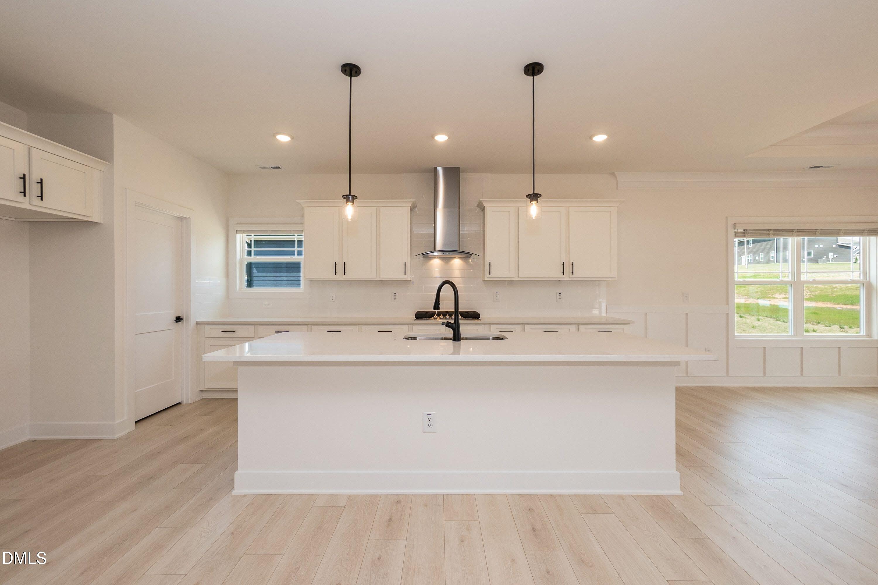 180 Galway Road Lillington, NC 27546 - Photo 4 of 41 a view of a kitchen with kitchen island a sink stainless steel appliances and a window