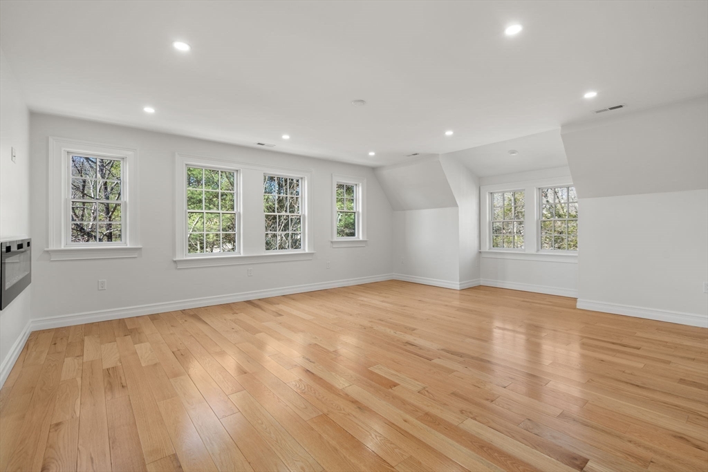 10 Hitching Post Lane Weston, MA 02493 - Photo 25 of 42 a view of an empty room with a window and wooden floor