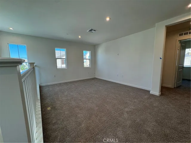 an empty room with windows and closet