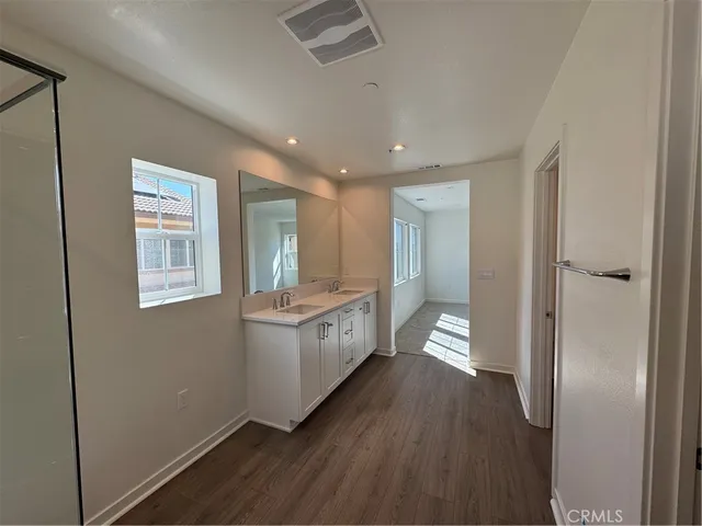 a large bathroom with a large mirror vanity and shower