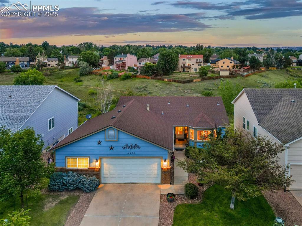 an aerial view of a house with a yard
