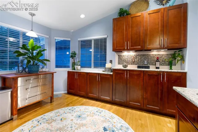 a kitchen with stainless steel appliances granite countertop wooden cabinets a stove a sink and dishwasher