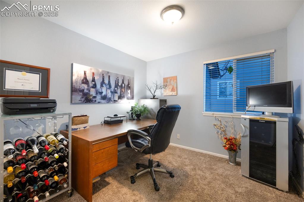 6370 Perfect View Colorado Springs, CO 80919 - Photo 15 of 49 a view of a workspace with furniture and a window