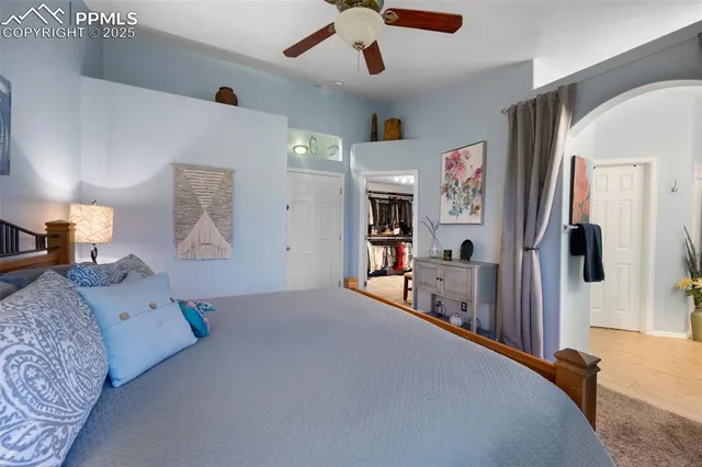 a bedroom with furniture and a flat screen tv