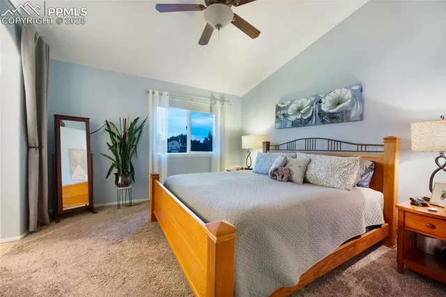 a spacious bedroom with a bed and a potted plant