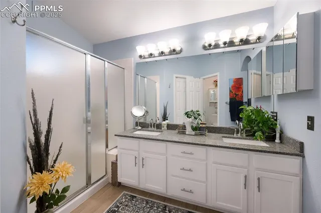 a spacious bathroom with double vanity and a mirror